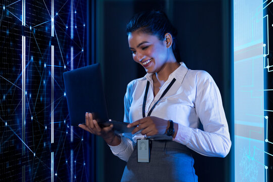 Female Technician/programmer working on the server in the data storage room