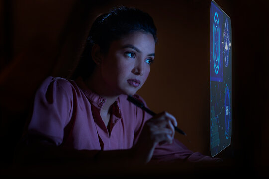 Businesswoman working with icons on virtual screen