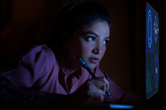 Businesswoman working with icons on virtual screen