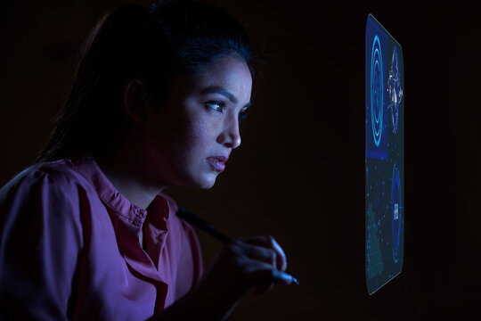 Businesswoman working with icons on virtual screen