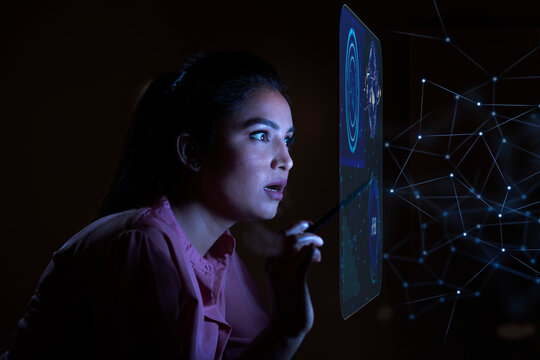 Businesswoman working with icons on virtual screen