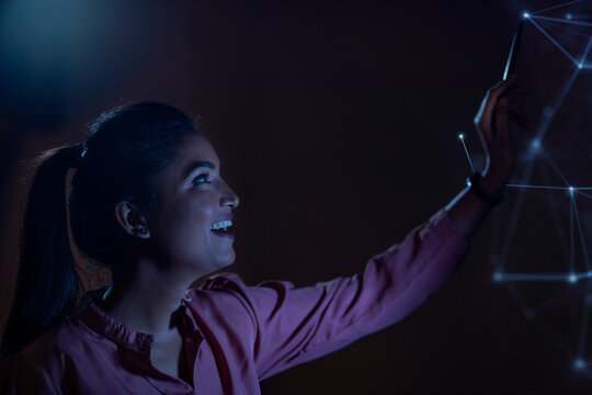 Businesswoman working with icons on virtual screen