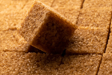 A symbol of food crisis, an full pack of brown sugar cubes highlights the divide between those who have access to abundance of food and those who are struggling with food insecurity - 561203614