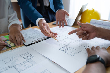 Businessman and architect meeting for planing and checking house design and house model and...