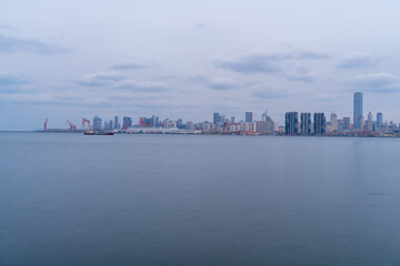 Dalian city reflected on the sea at dusk.