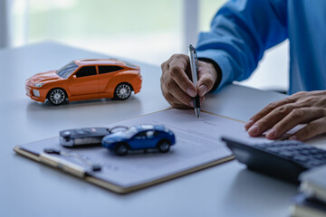 A car dealer or sales manager offers to sell a car and explains the terms of signing a car and insurance contract. - obrazy, fototapety, plakaty