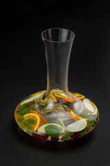 Jug of iced sangria isolated on black background