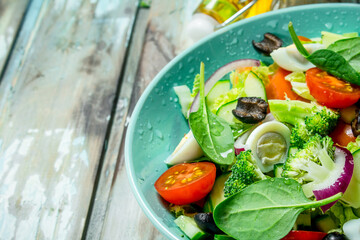 Vegetable salad. Salad of tomatoes, cucumbers and quail eggs with olive oil.