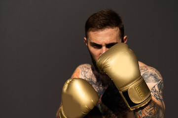 Part of man wearing boxing gloves.