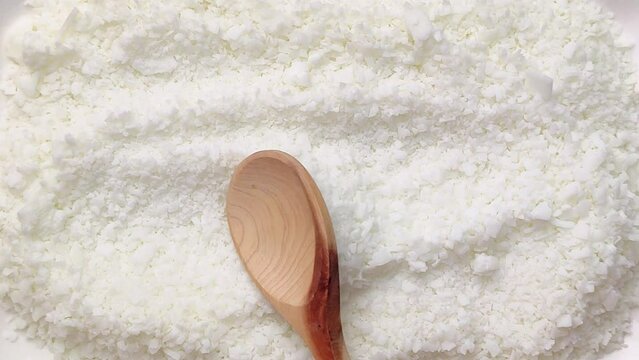 macro shot of soy wax flakes for candle making. Soy wax flakes falling