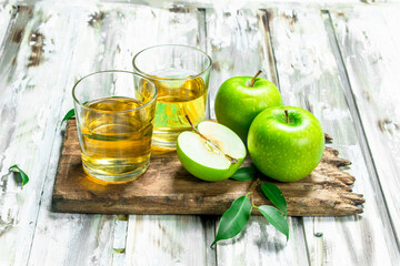 Apple juice in a glass Cup on a wooden Board.