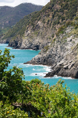 View of the Mediterranean Sea coast, turquoise water and surrounding rocks, Cinque Terre, Italy