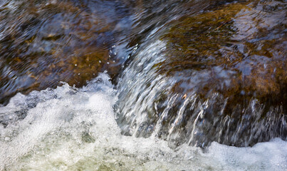 Close up of river stream on stones