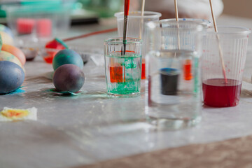 Rinse brush in glass of water while painting Easter eggs