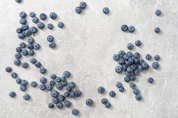 Top view of a group of fresh blueberries on gray background.