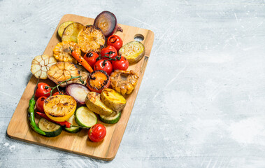 Grilled vegetables with spices and herbs on a cutting Board.