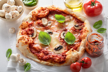 Fresh and aromatic pizza made of tomatoes and mushrooms.