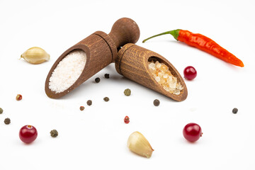 Salt in wooden spoons, spices  isolated on a white background.