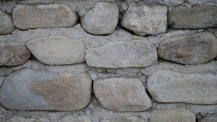 Neatly stacked rough cut stone wall seamless texture background