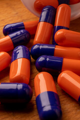 A picture of blue and orange pills, symbolizing the power of nature in providing healing and treatment - 561214610