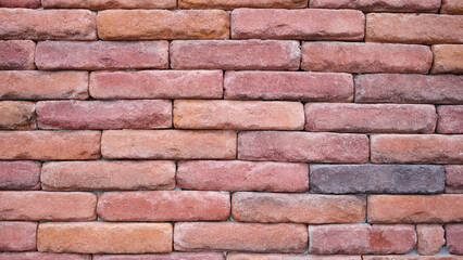 Texture of the wall of old red brick closeup
