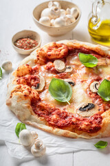 Homemade and tasty pizza made of tomatoes and mushrooms.