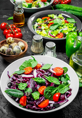 Vegetable salad. A variety of organic salads, vegetables with olive oil and spices .