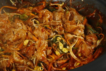 Korean spicy pork dish with carrots and soybean sprouts