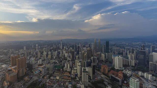 Aerial day-time time lapse overlooking a wide view of a city skyline with dancing rays before sunset in Kuala Lumpur, Malaysia. Prores 4K DCI