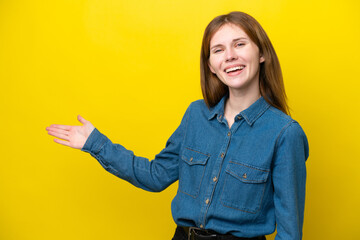 Young English woman isolated on yellow background extending hands to the side for inviting to come