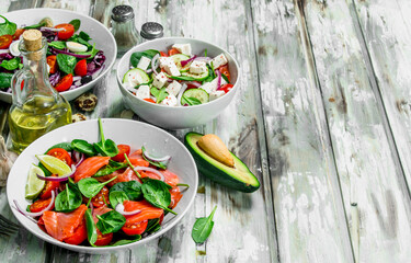 Various salads of organic vegetables, fish and cheese with olive oil and spices .