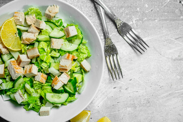 Healthy salad. Salad with cucumbers, chicken and Chinese cabbage poured lemon juice .
