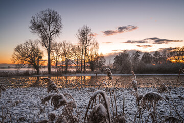 Sunset during winter over flooded countryside