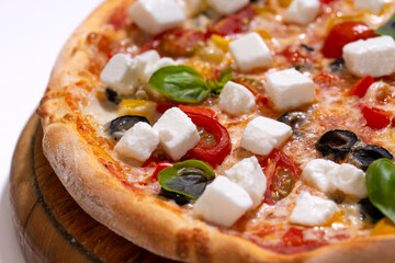 freshly baked pizza with feta cheese slicers on white background