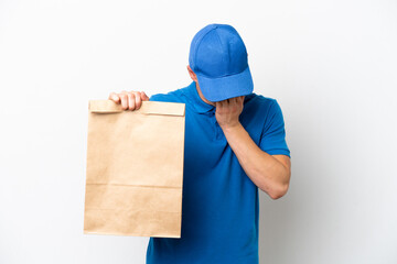 Young Brazilian man taking a bag of takeaway food isolated on white background with tired and sick expression