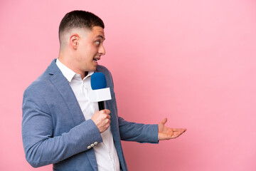 Young brazilian presenter man isolated on pink background with surprise expression while looking side