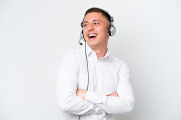 Telemarketer Brazilian man working with a headset isolated on white background happy and smiling