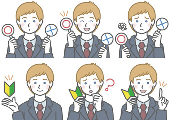 〇✕マークや初心者マークを持つ、スーツを着た若い白人男性