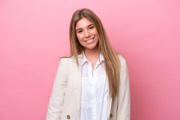 Fototapeta premium Young caucasian woman isolated on pink bakcground laughing