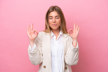 Young caucasian woman isolated on pink bakcground in zen pose