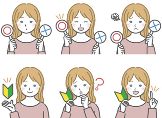 〇✕マークや初心者マークを持つ、白人の少女