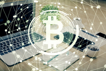 Double exposure of blockchain and crypto economy theme hologram and table with computer background. Concept of bitcoin cryptocurrency.