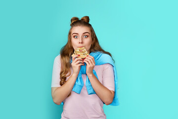 surprised young woman biting a pizza slice