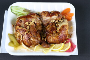 Grilled Chicken Meal with Nuts and Slices of Carrots Lemons Cucumbers Peppers and Pickles  Meat Dishes Stock Photos 2