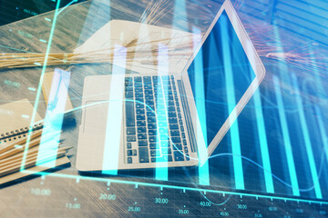 Financial market graph hologram and personal computer on background. Double exposure. Concept of forex.