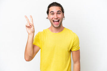 Naklejka premium Caucasian handsome man isolated on white background smiling and showing victory sign
