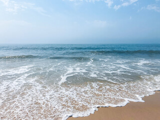 calm blue shallow waves on the beach