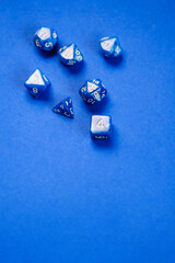 blue polyhedral bones on a blue background. A collection of beautiful polyhedral dice (d4, d6, d8, d10, d12 and d20) for fantasy games.dice and role playing board games