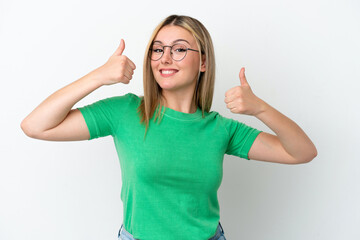 Fototapeta premium Young caucasian woman isolated on white background giving a thumbs up gesture