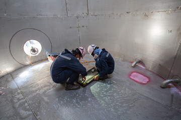 Male worker inspection vacuum test weld tank stainless steel